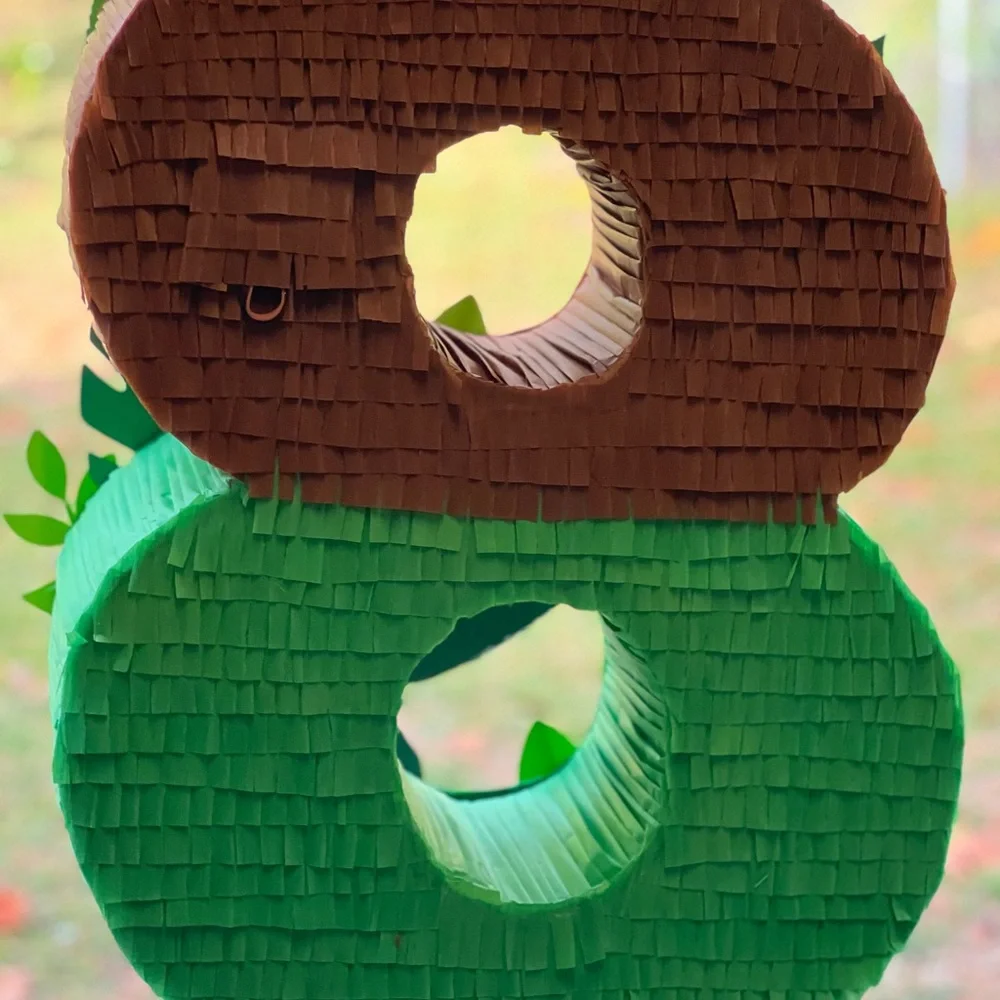 Dinosaur-Themed Party Decoration with Green and Brown Accents